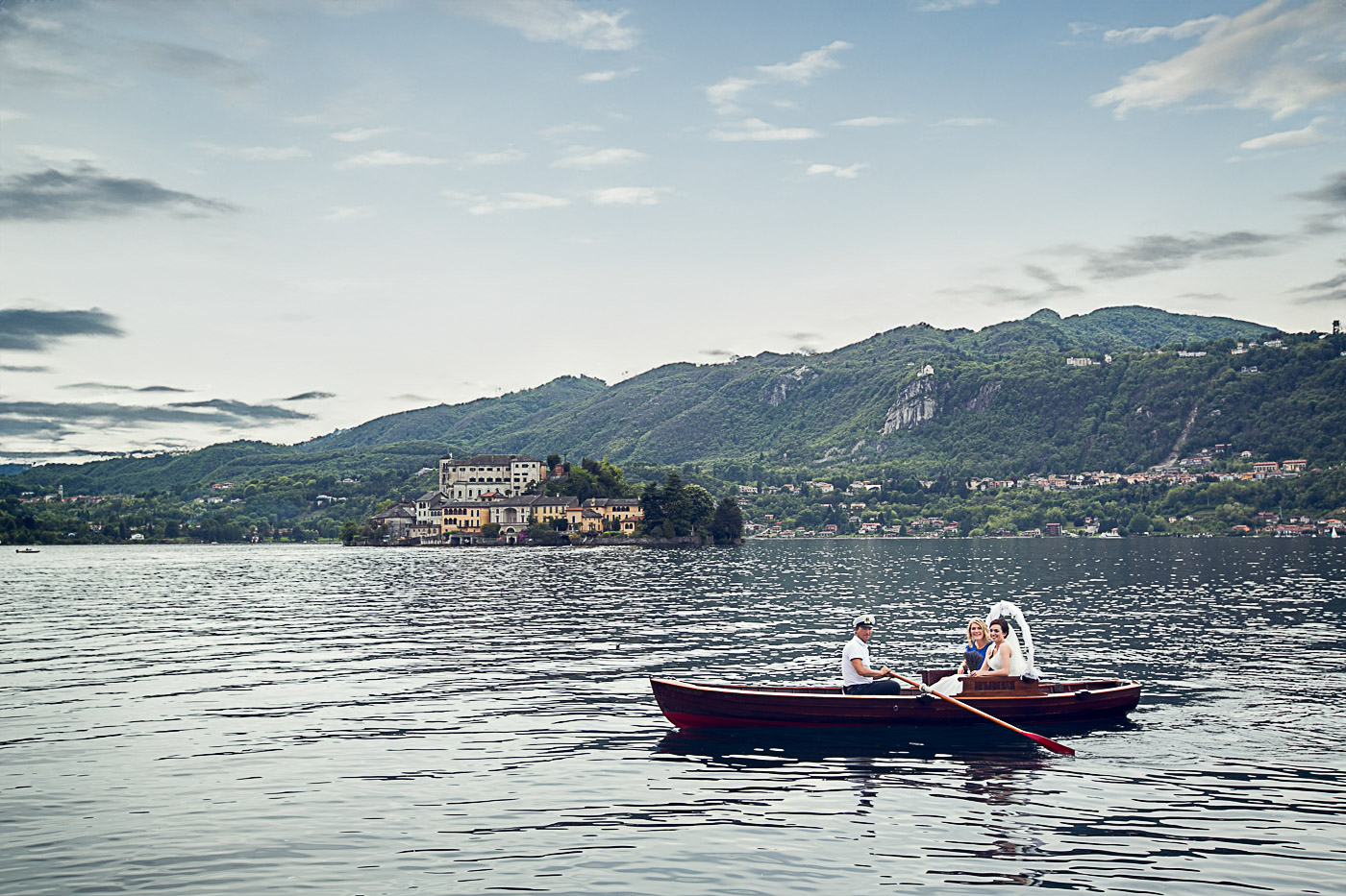 bride on a rowing boat reaching the ceremony