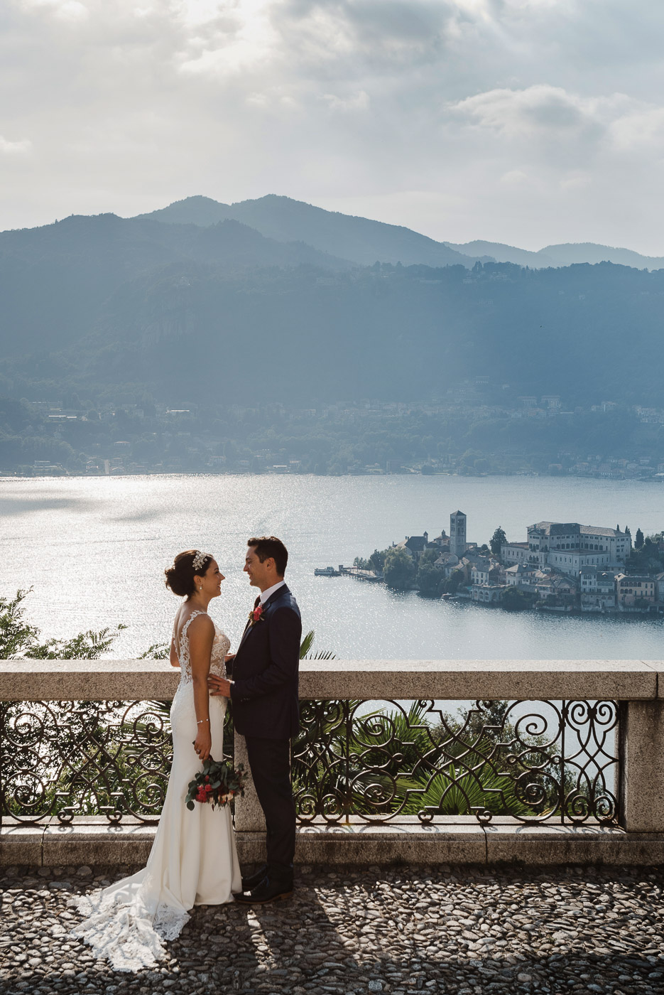 bride and groom with Orta San Giulio island in the background