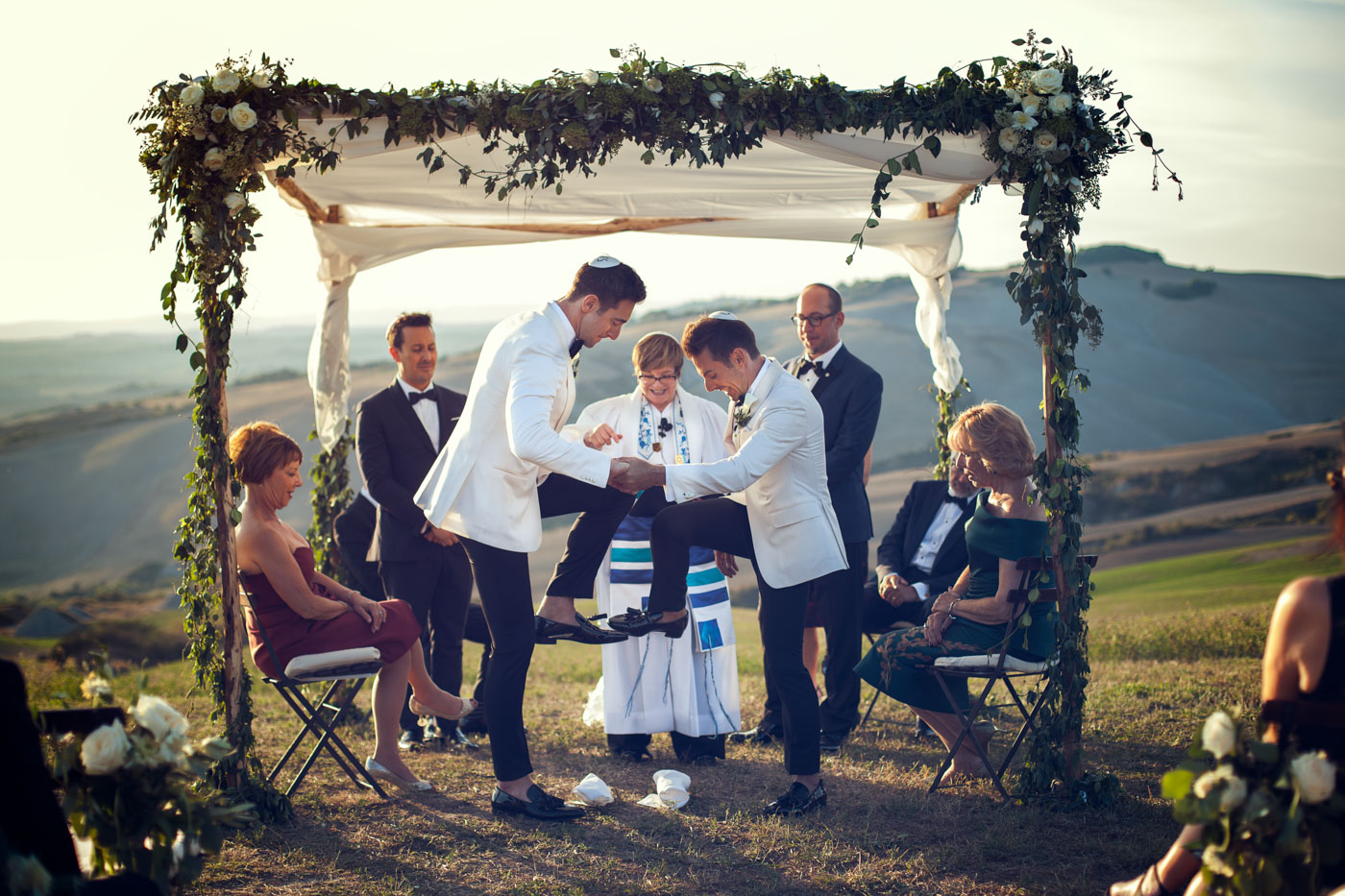 same sex Jewish wedding in Italy, both grooms are breaking the glass