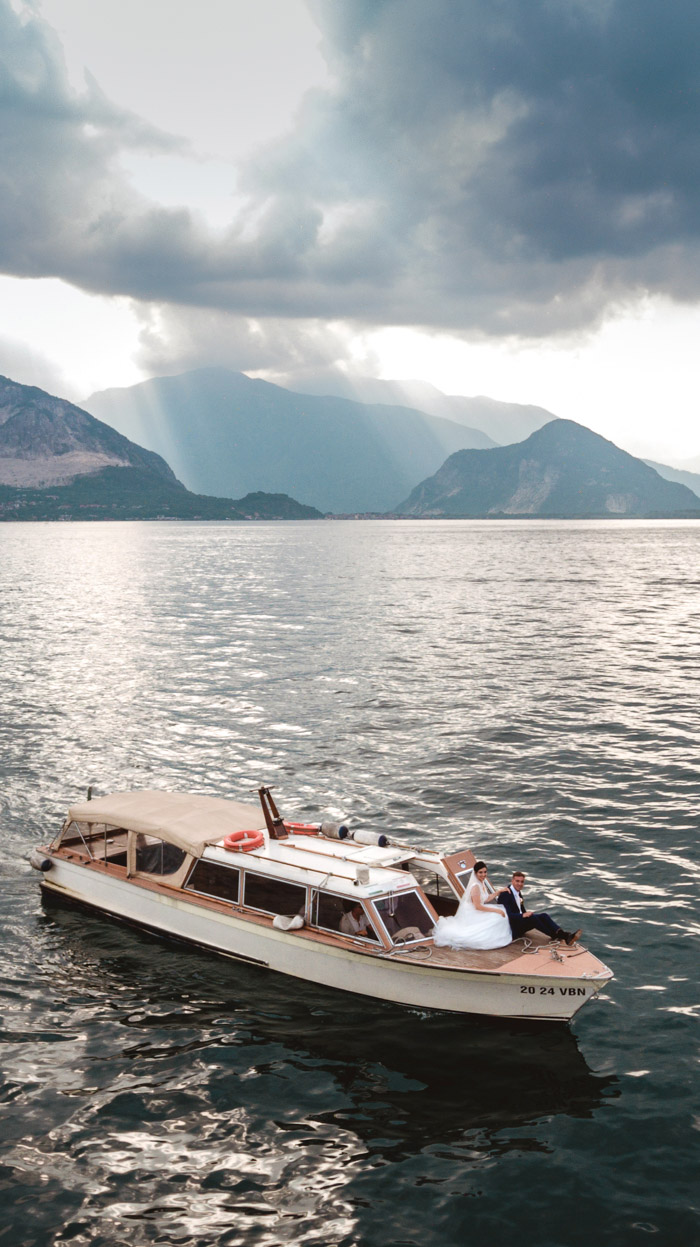 Lake Maggiore wedding photographer, drone shot of bride and groom on boat and stunning lake maggiore view